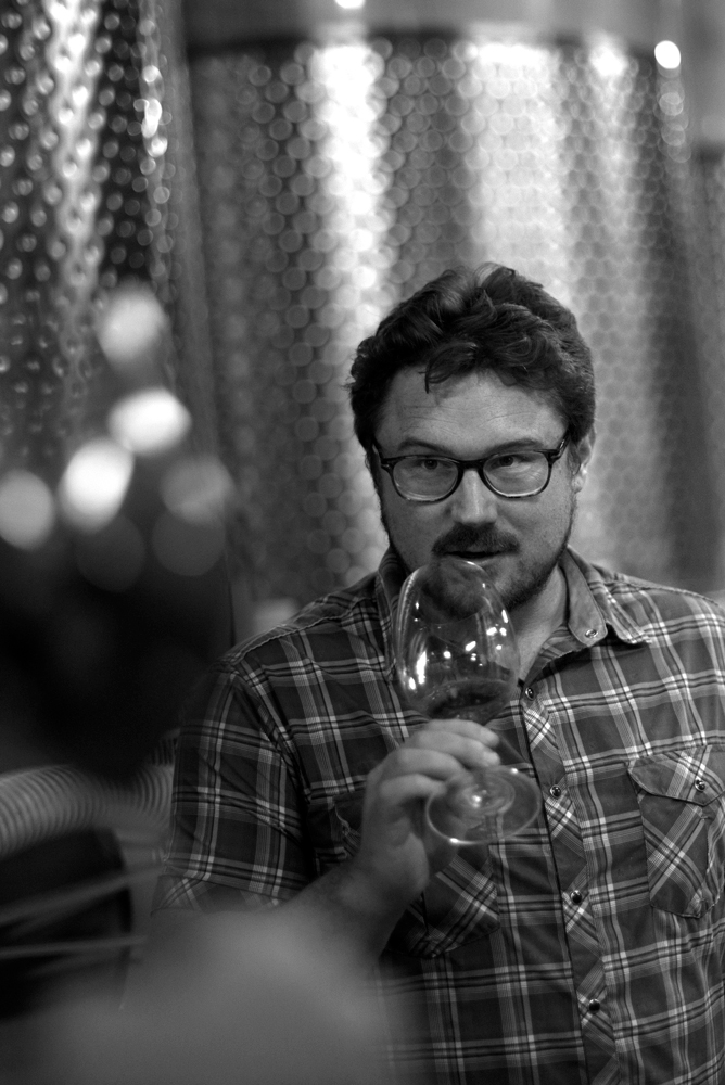 Morgan Twain-Peterson smelling a glass of wine at Bedrock Wine Co.